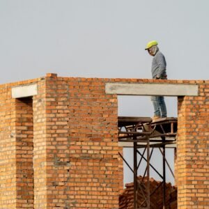a man standing on top of a brick building