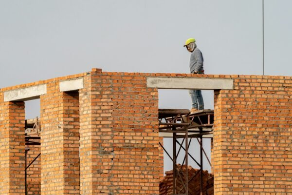 a man standing on top of a brick building